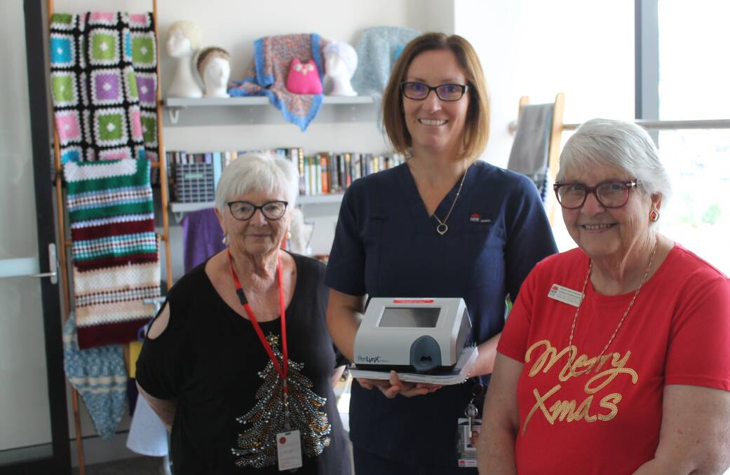 Hospital Auxiliary members Marian Cowell and Jan Bransgrove, with Jackie Hattam and the fetal fibronectin point of care testing equipment that the group purchased for the Maternity Unit. 