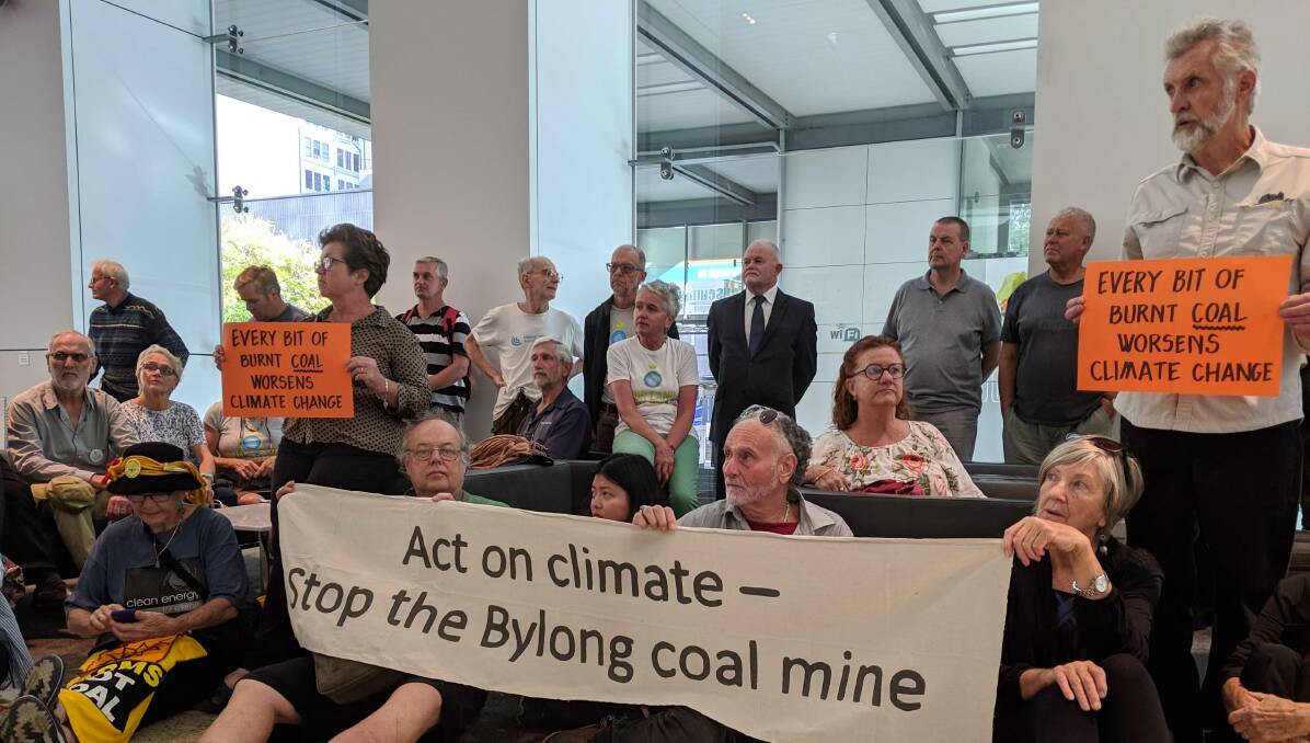 Sit-in: Bylong farmers backed by Lock the Gate take a seat at the IPC, which is deciding the fate of the controversial proposed mine.
