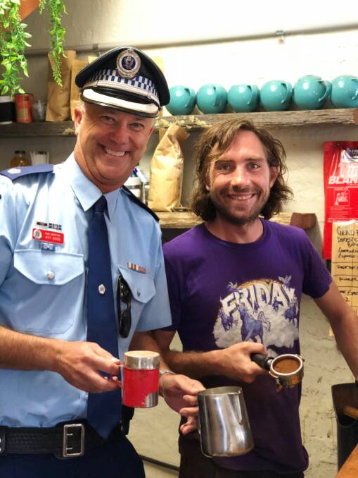 Chief Inspector Jeff Boon with Barista Mark Newman at Mockingbird Cafe in Lovejoy Village on International Coffee with a Cop day.