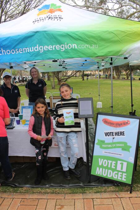 Eden and Ruby Azar lend a hand with voting for the Festival of Snags, at the Farmers Markets on Saturday.