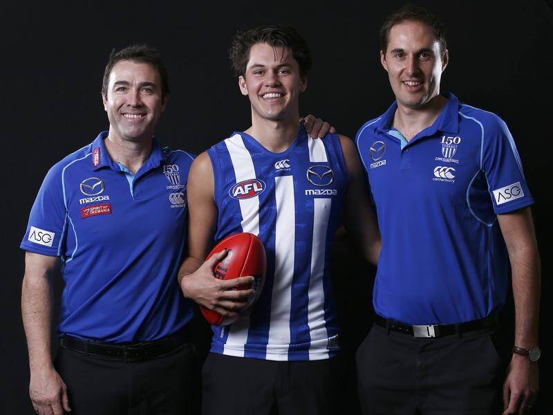 North Melbourne coach Brad Scott (L) has called for calm over changes to rules for AFL runners.