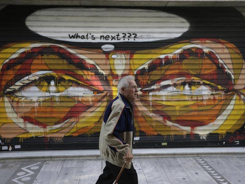 Greece's PM says paying off final installment of a $A46b loan to the IMF marks 'end of an era'.