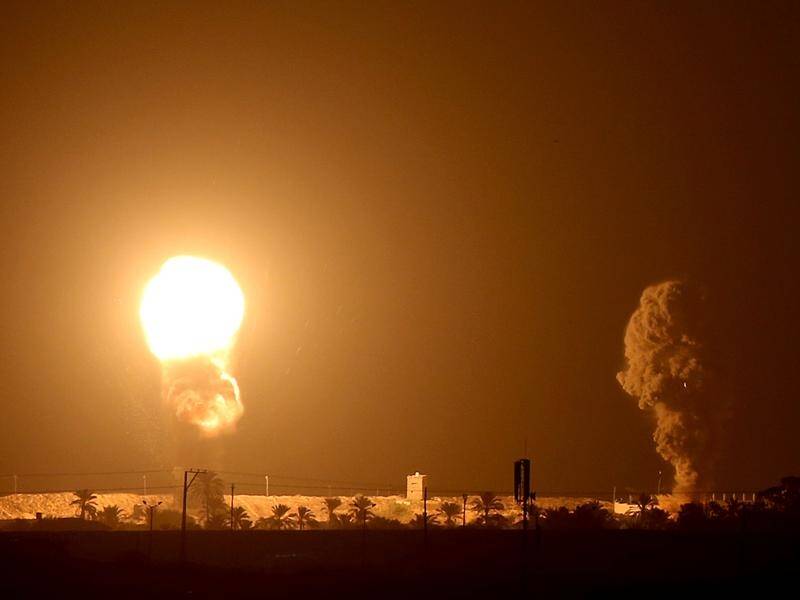 Smoke and flame are seen following an Israeli air strike in the southern Gaza Strip.