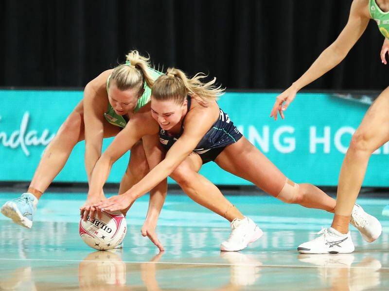 Fever's Jessica Anstiss battles for possession with the Vixens' Kate Moloney in their netball clash.