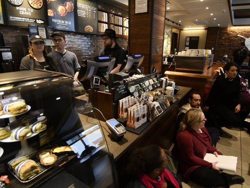Protesters stage a sit-in at a Philadelphia Starbucks where two black men were arrested.