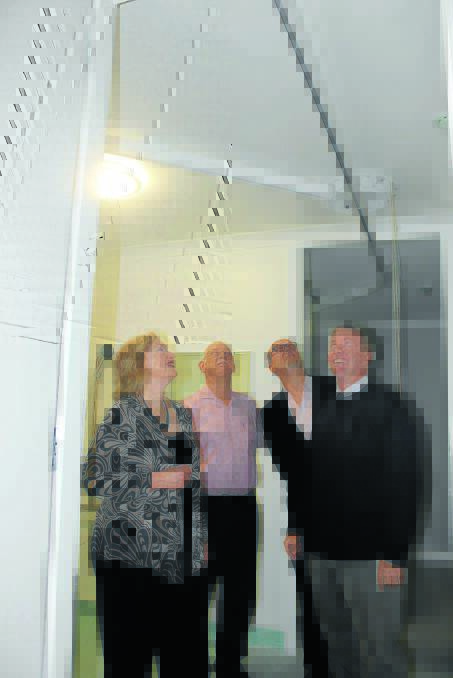 RIGHT: 
Lifeskills Plus CEO Carolyn Peek, treasurer Bruce Walker, business and community liaison officer Bob Lejeune with member for Parkes, Mark Coulton in stage one of the community centre. The hoist above them will allow carers to move clients from bedrooms to the bathroom and lounge room without the need for heavy lifting. 
080515 ew lifeskills 1757