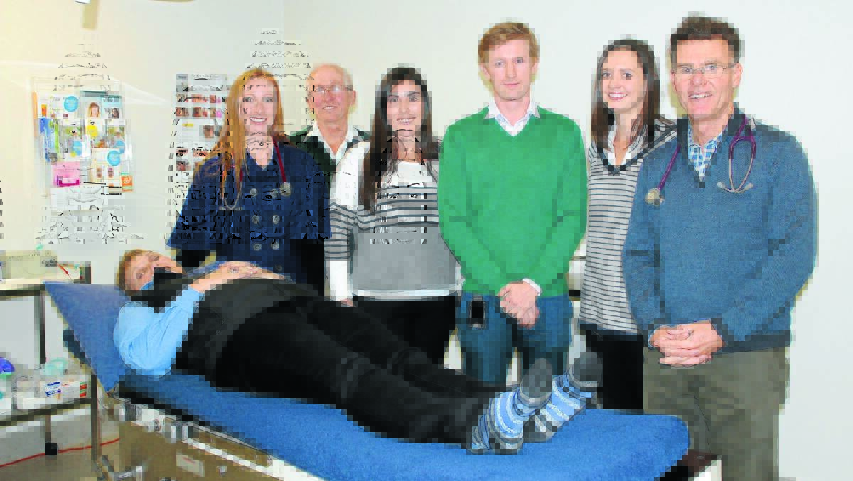 Medical students Louise Thomas, Emily Sideris, Hugh Stump, and Hannah Watson take a look at patient Donna Doherty with help from doctors Gary Moore and Peter Roberts.