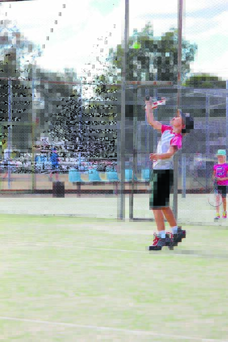 Sam Roth serves during the junior tennis competition on Monday. PHOTO: DARREN SNYDER