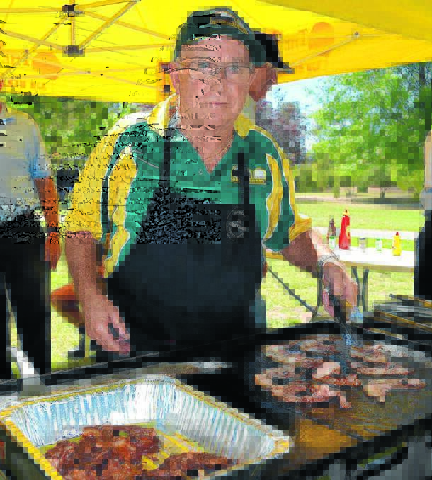 Jim Cruickshank from Mudgee Men's Shed fires up the bacon on the barbecue.