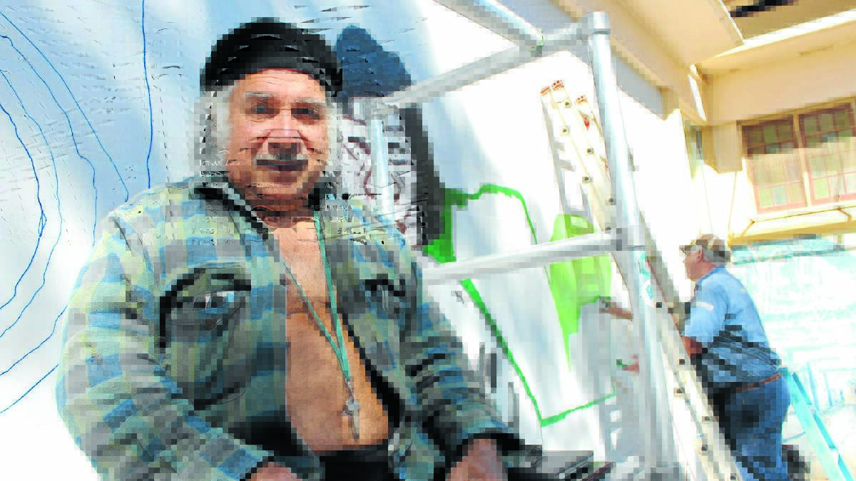 Artists Djon Mundine, with Ed Windell in the background, will complete a permanent mural at the Kandos Museum as part of the 2015 Cementa Arts Festival.