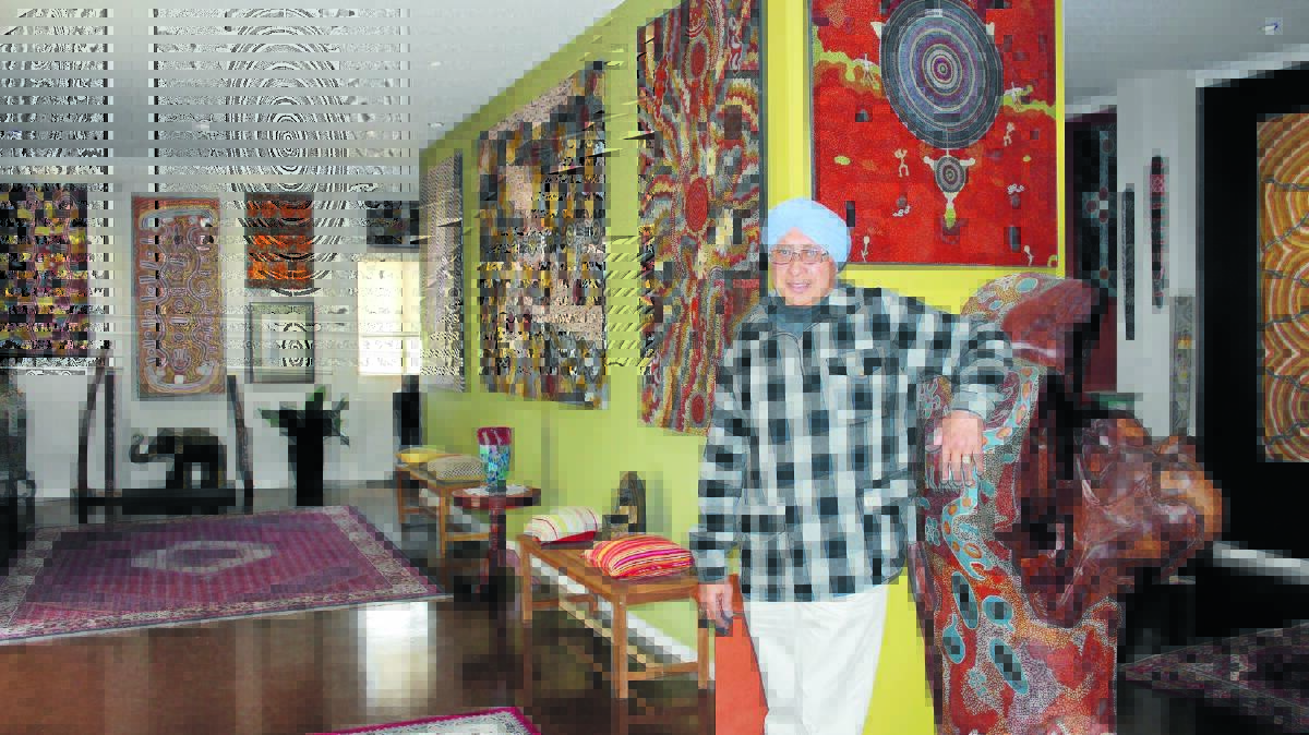 Local art collector Gora Singh Mann poses with just some of the many pieces of Aboriginal art he has  collected over the years.