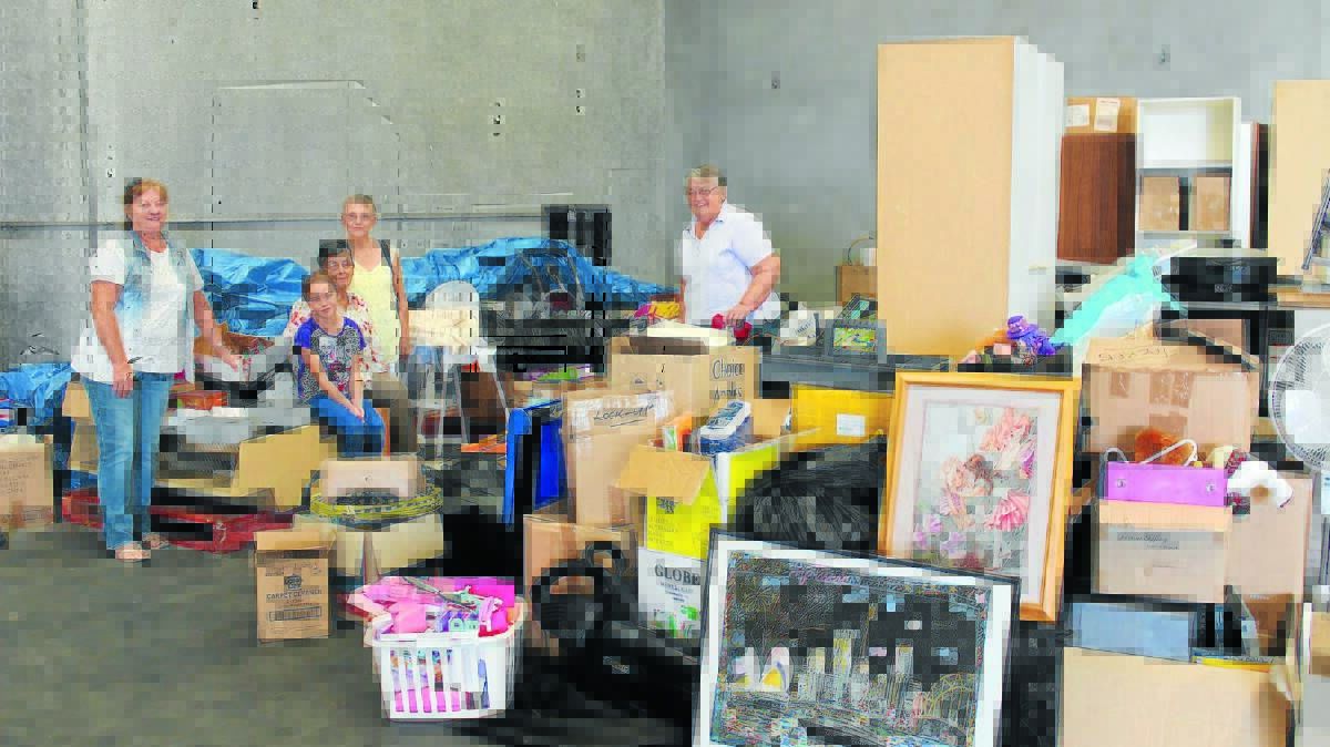 Friends of Lifeskills members Narelle Salter, Kaasha Salter, Judy Rowbottom, Sandy Walker, and Jill Sonter stand amongst just one of the rooms of donations the group has received for their giant garage sale on May 2 and 3.