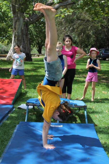 Jaya Maddock-Delph demonstrates a cartwheel at the Mudgee Gymnastics stall at the Health and Fitness Festival on Saturday.