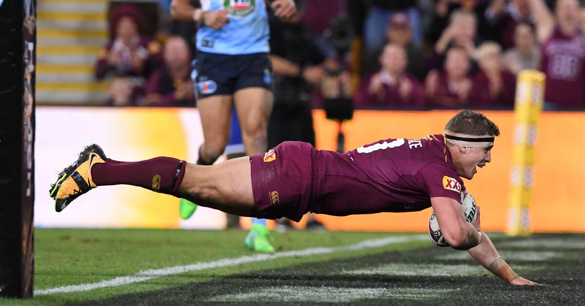 FIRST TIME: Jarrod Wallace crosses for his first State of Origin try as the Queensland dynasty rolls on at Suncorp Stadium. Photo: AAP