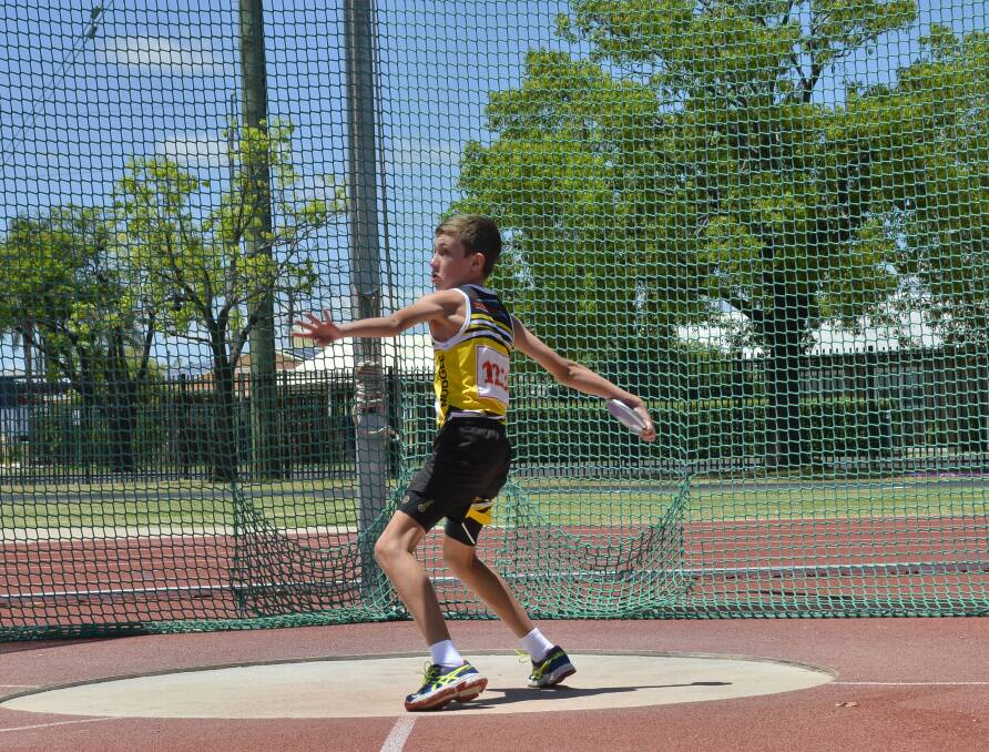 FAR-FLUNG: Mudgee's Connor Whale competing in the discus event at the Annual New Year Carnival, and set a new record in the Boys' 12 800 Meter Dash with a time of 3:00.4. Photo: Paige Williams.