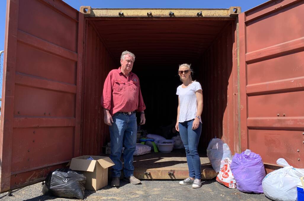 Roger Andrews and Peta Ryan loading the shipping container with donations. Photo: Benjamin Palmer