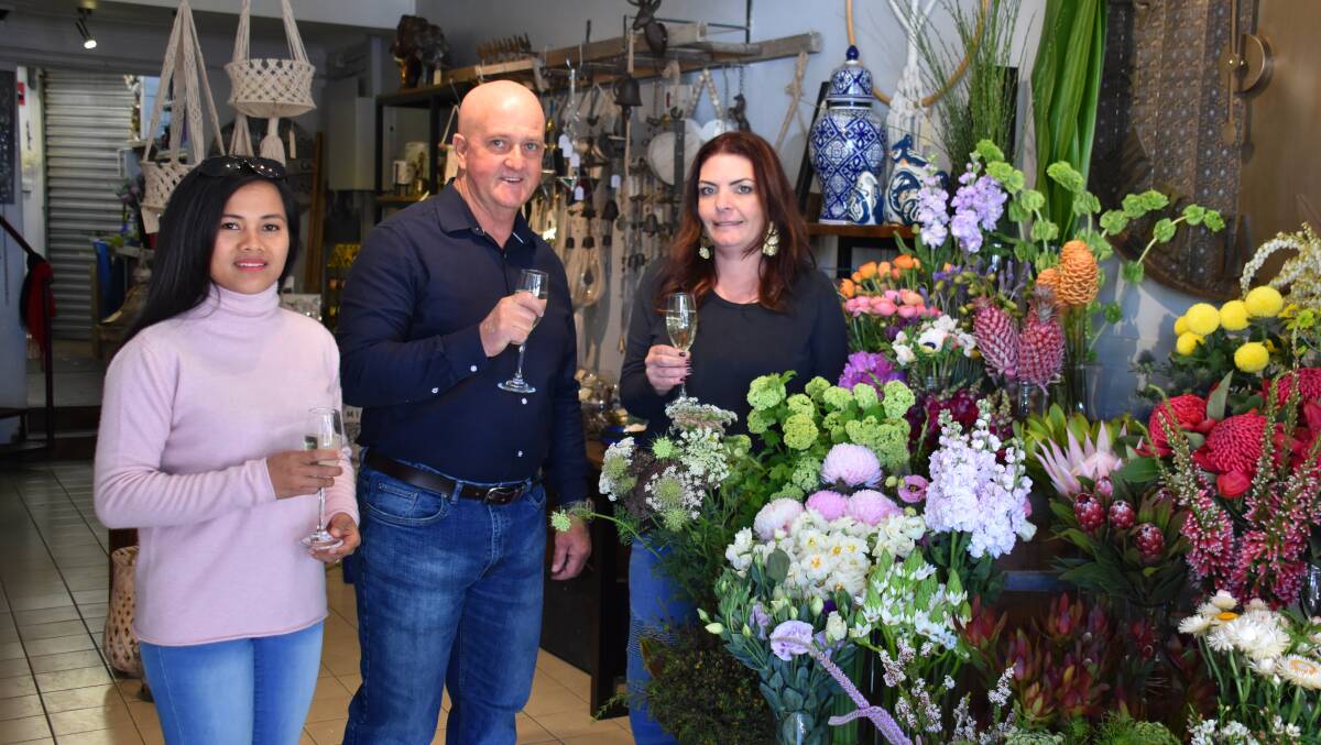 BUSINESS: Geoff Byfield with his wife Roselyn and Cearna Illy from Mudgee Flower Obsession who accepts Qoin. Photo: Jay-Anna Mobbs