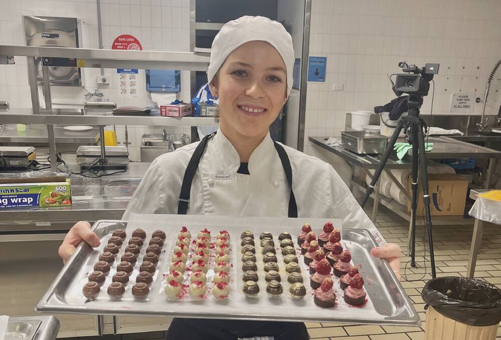 Lucy Tanner-Norman in the kitchen with an impressive tray of chocolates. Photo: Supplied
