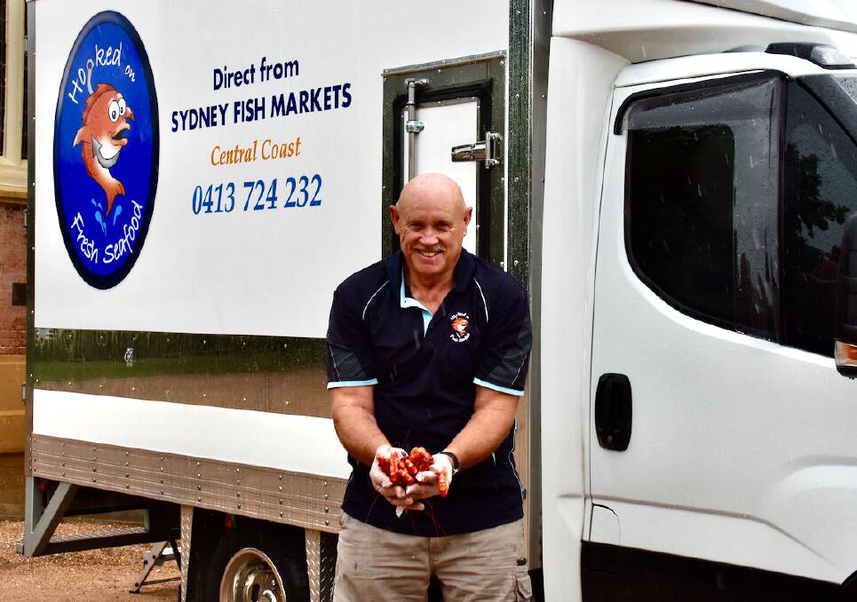 CATCH: Kent Baldwin with some fresh prawns out the front of his truck stationed at the Mudgee St John's Anglican Church. Picture: JAY-ANNA MOBBS