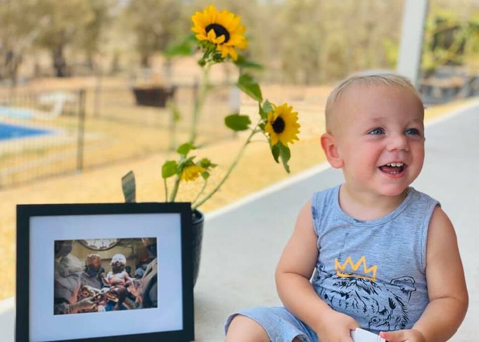 LOVE: Miller's brother Myles with a photo of Miller at his birth. Photo: Facebook / Alanah Lewis, Jeff Dray