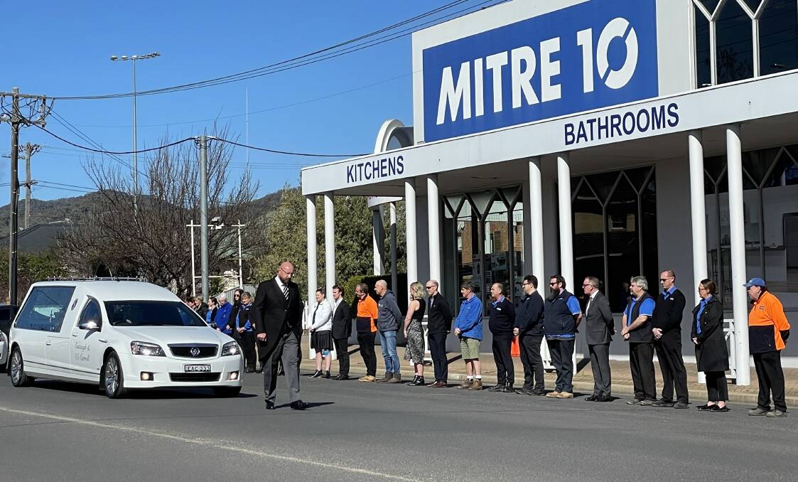 A guard of honour outside of Petrie's Mitre 10 on Monday by staff. Photo: Supplied / Eastaugh and Carroll