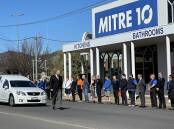 A guard of honour outside of Petrie's Mitre 10 on Monday by staff. Photo: Supplied / Eastaugh and Carroll