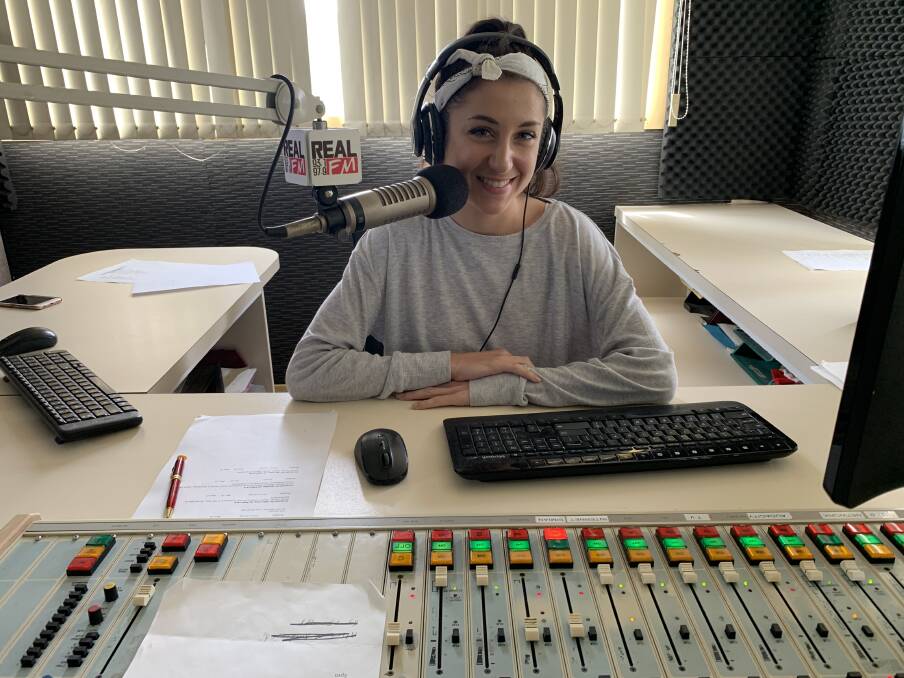 Ariana at the desk ready to go on-air.