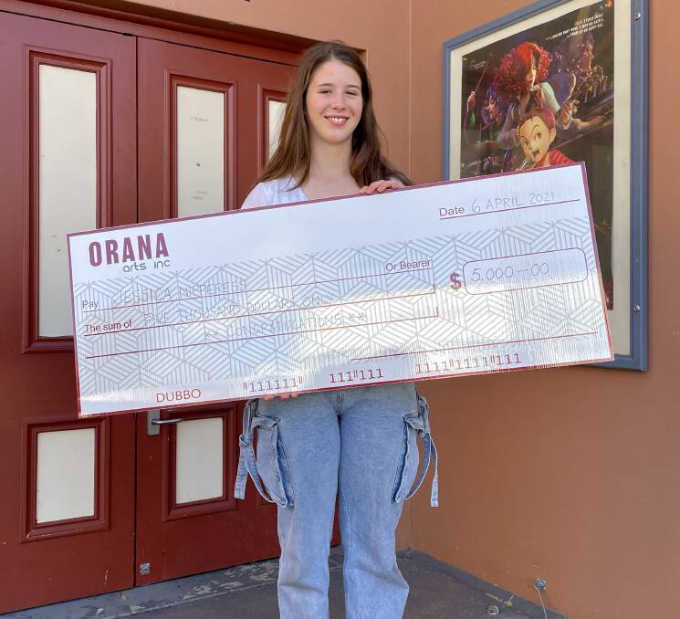 Jessica with her big cheque that will help bring her dream project to life.