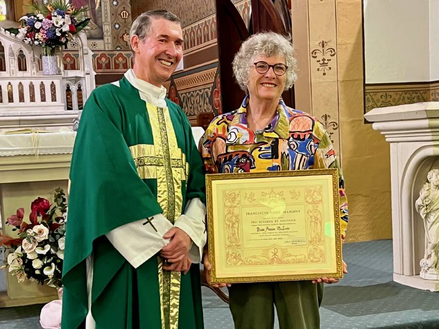 Father Owen Gibbons with Anne McLean presenting her the accolade. Photo: Supplied