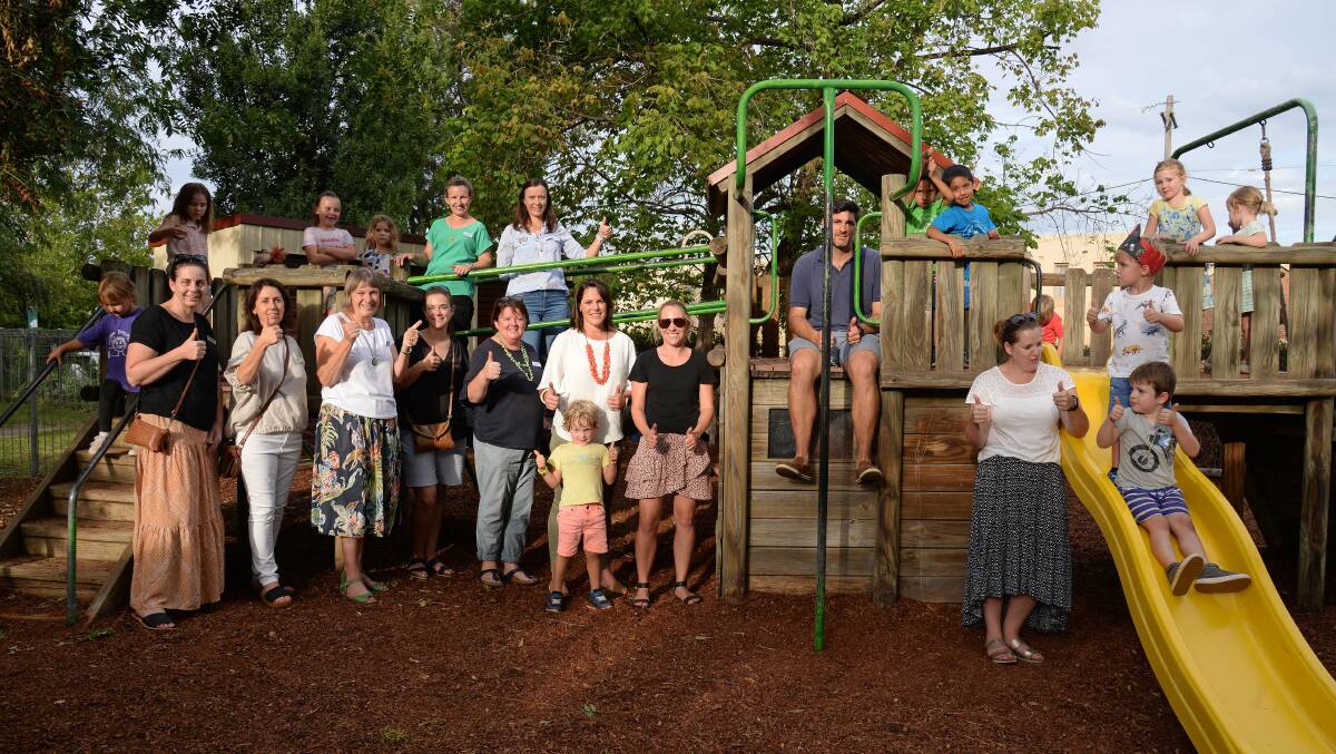 NOW: Families and staff stand with the old fort at Mudgee Preschool in 2020. Photo: Supplied.