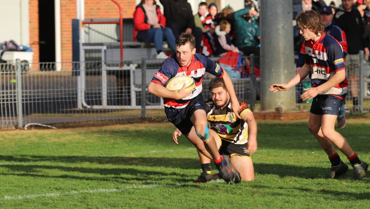 SPECIAL CLUB: James 'Fordy' Ford in action against CSU at Jubilee Oval in his 100th game for the Mudgee Wombats. Photo: Peter Sibley