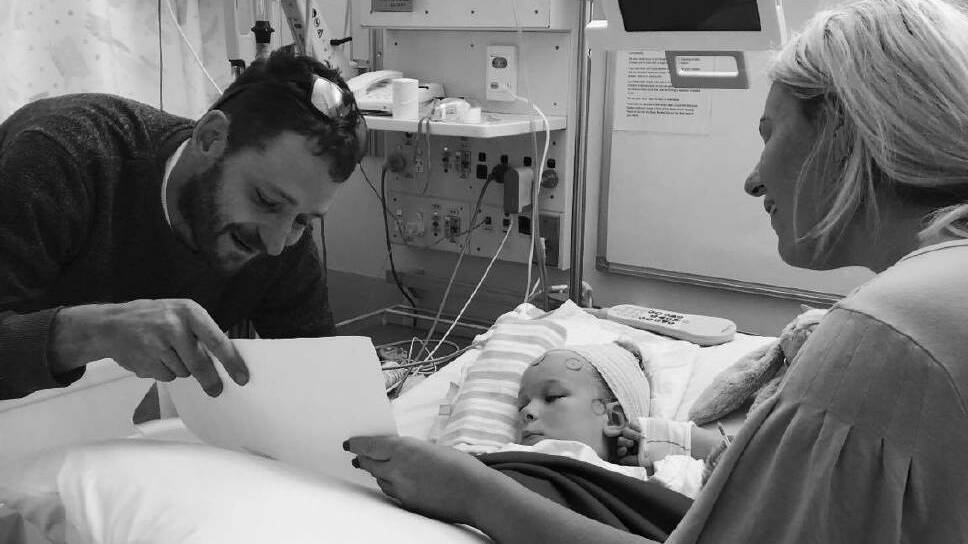 Mia in hospital with her parents by her side in 2019. Photo: Facebook / Stacey Bennett