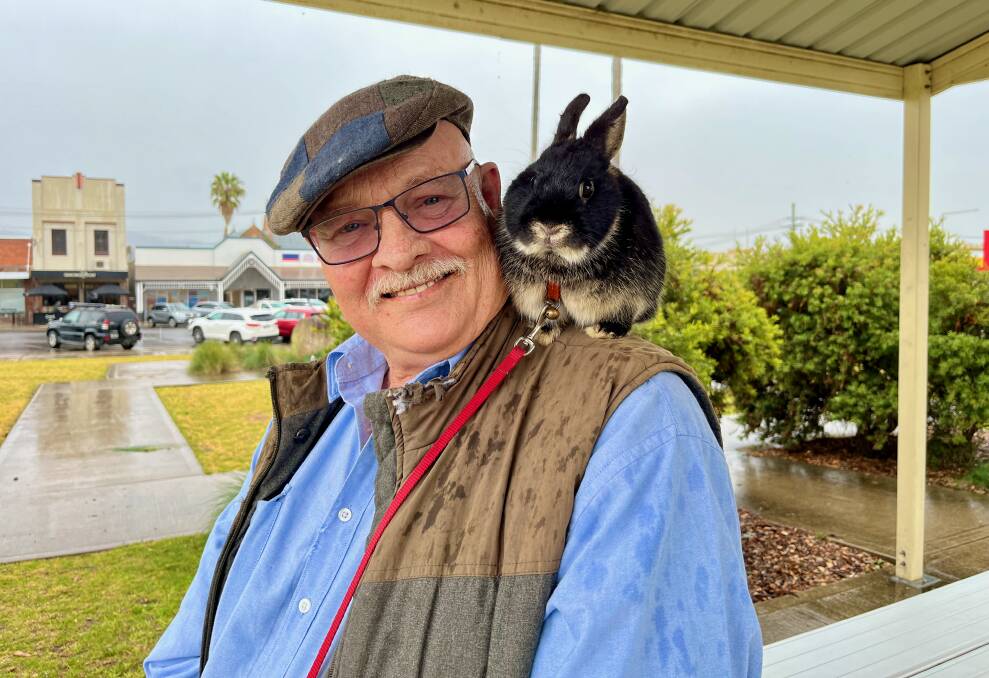 Trevor Larsen poses with his friend and companion, dwarf rabbit 'mini midnight'. Photo: Benjamin Palmer