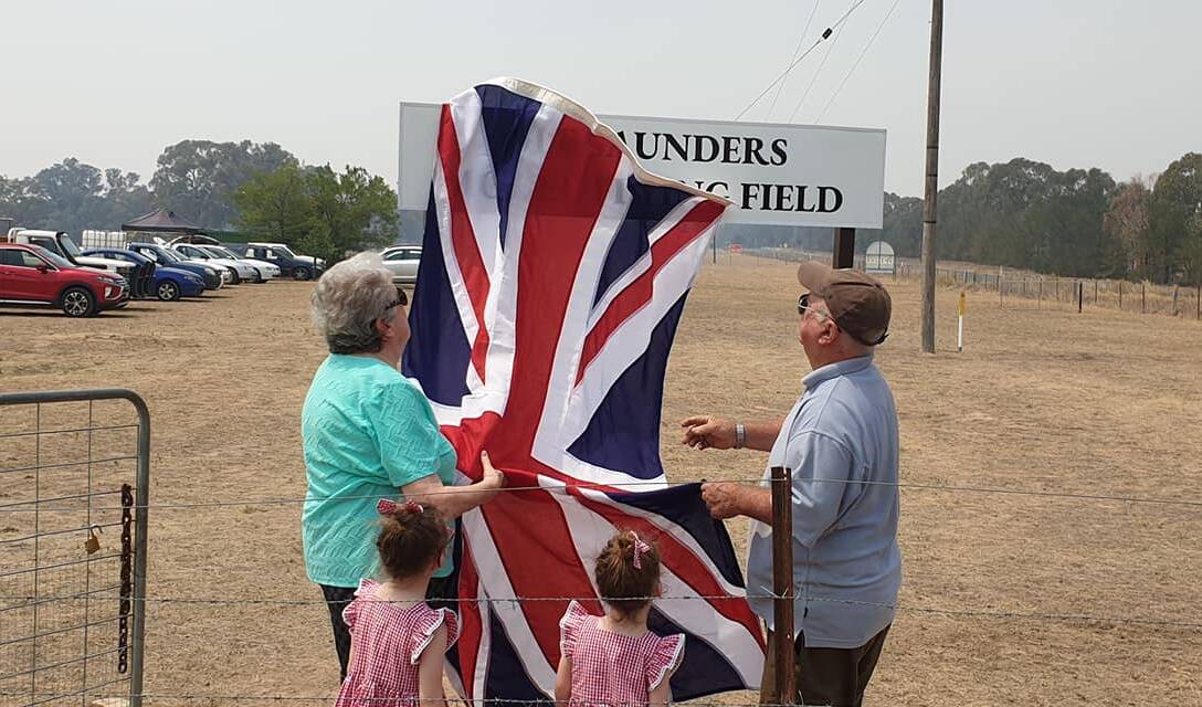 FLAG: Alf's wife Maureen with Clifford unveiling the sign while great-granddaughters Hazel and Lily look on. Photo: Janet O'Hare