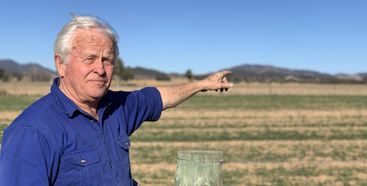 Mr Cox pointing to the land in the distance where the solar farm is set to be constructed. Photo: Benjamin Palmer