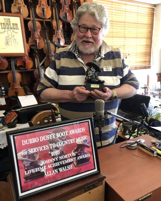 CONTRIBUTION: Allan Walsh in his shop The Fiddlers Hame with the Johnny Norton Lifetime Achievement Award for his contribution to country music. Photo: Joy Harrison