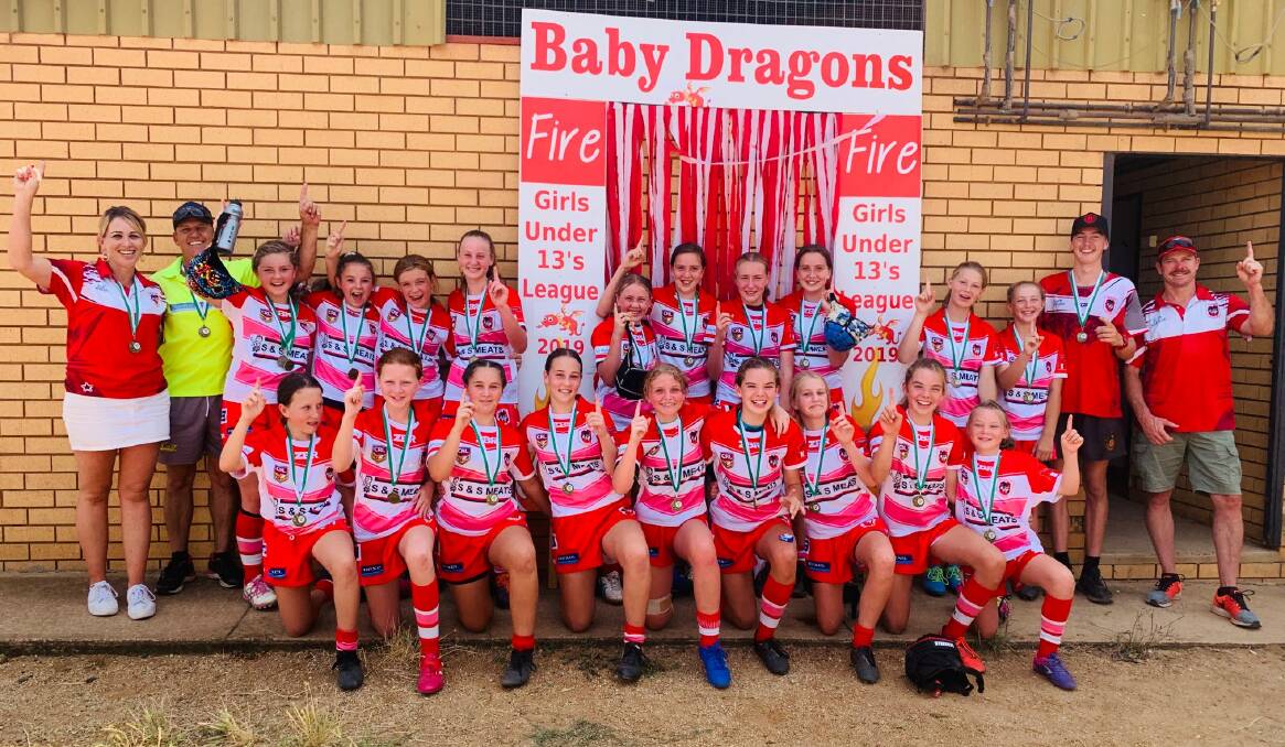 WE ARE THE CHAMPIONS: The Mudgee Dragons U13s girls side celebrate their win in Eugowra against the Orange Vipers. Photo: Hayley Joseph