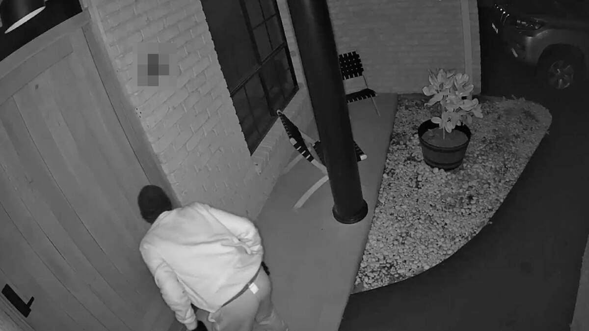 A screen capture showing a man attempting to open the front door to Aime Arthur's home in Mudgee (we have obscured the address). Supplied