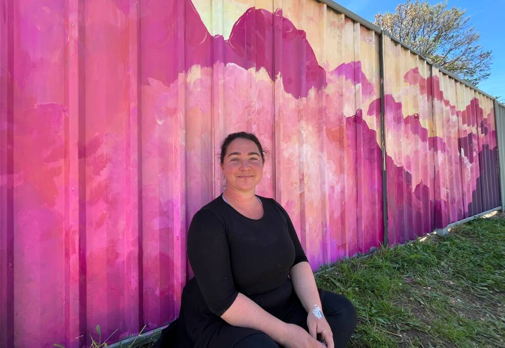Artist Emily Van Reason sat with her mural on Horatio Street.