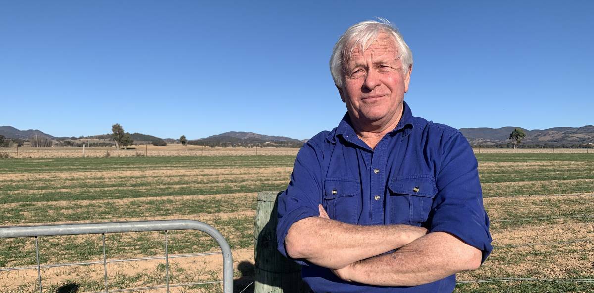 Ted Cox standing at the gate, several hundred metres away from a proposed site of a solar farm outside of Mudgee. Photo: Benjamin Palmer