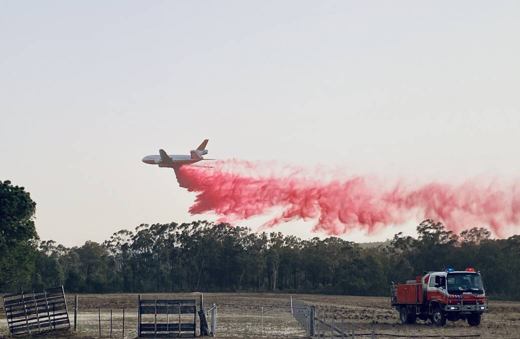 HEAVY RESPONSE: The RFS's 'Very Large Air Tanker' (VLAT)
dropping fire retardant on the Ulan fire on Tuesday. Photo: Maddie Thurlow