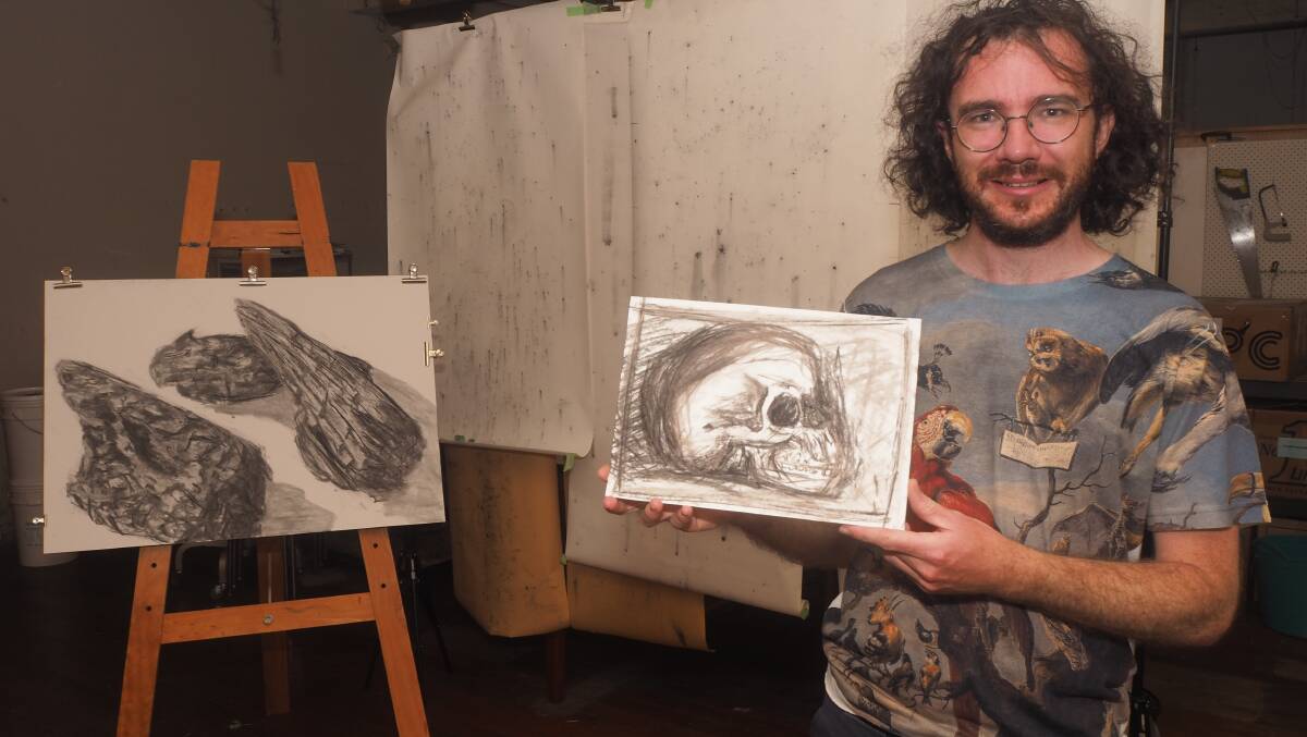 SHADES: Bathurst artist Julian Woods with some of the charcoal artworks to be featured in his upcoming Kandos solo exhibition. Photo: SAM BOLT