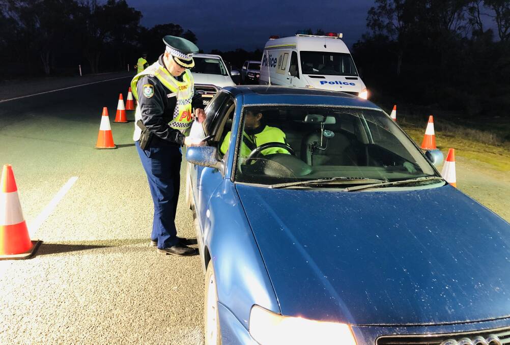 CHECK TIME: Western Region Assistant Commissioner Geoff McKechnie conducting checks at the Victorian-NSW border. Photo: NSW POLICE