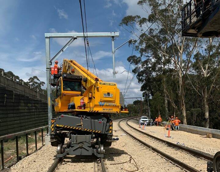 REPAIR WORK: Workers on site to repair damage caused by a significant landslide during heavy rain in early February. Photo: SYDNEY TRAINS