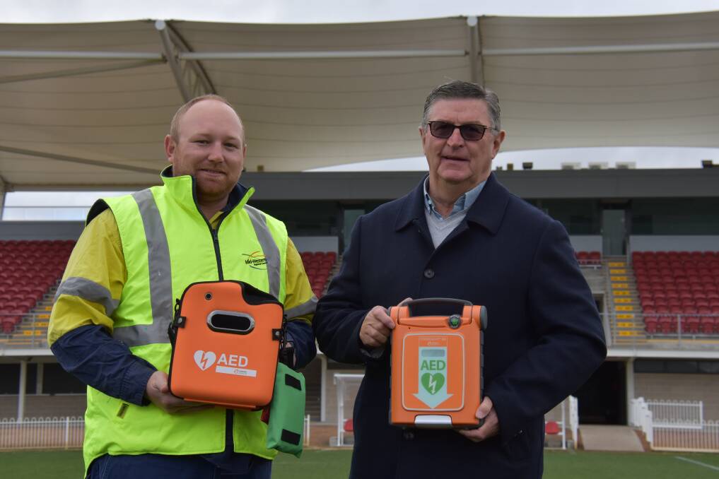 LIFE SAVING: Mid-Western Regional Council mayor Des Kennedy and senior greenkeeper Josh Martin with the newly-purchased defibrillator at Glen Willow Stadium. Photo: JAY-ANNA MOBBS