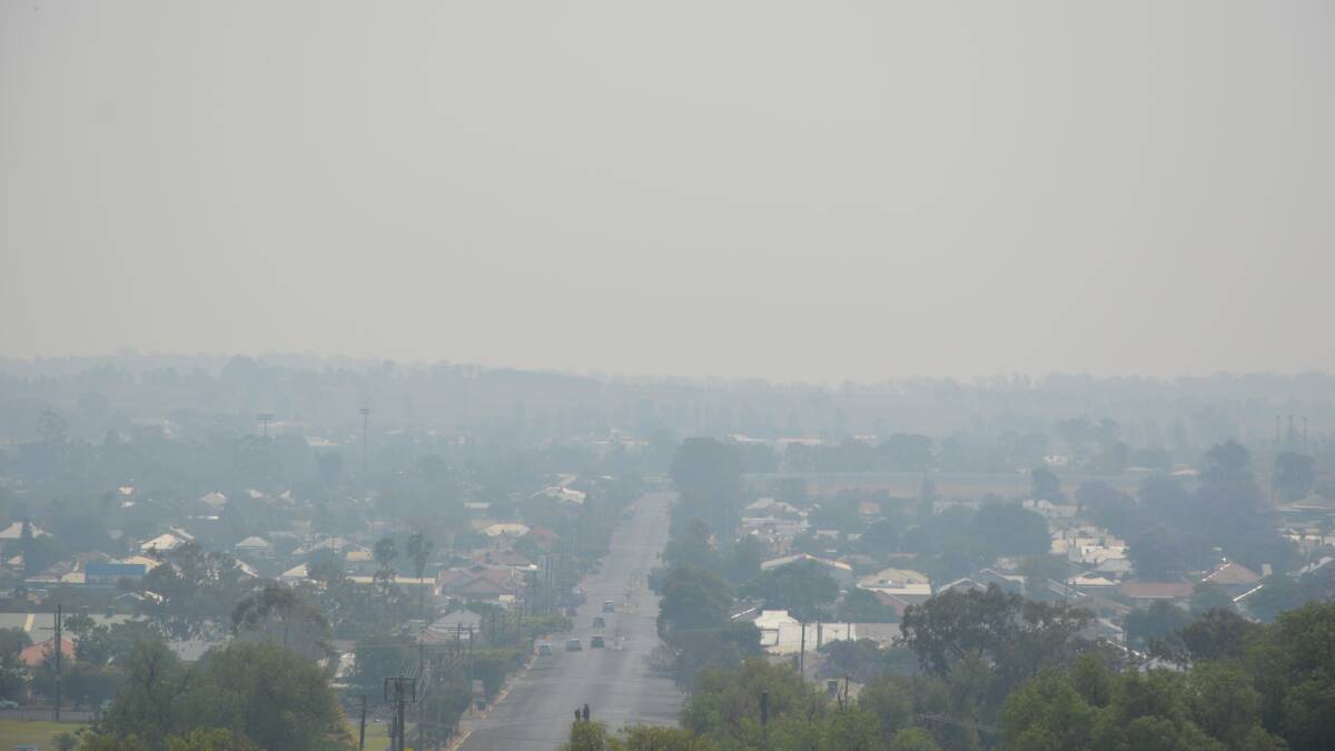 HAZY: Parkes residents awoke to the smell of smoke on Thursday, with the hazy conditions lingering around all day and causing a hazardous air quality level. This photo overlooks Victoria Street in Parkes. Photo: BARBARA REEVES