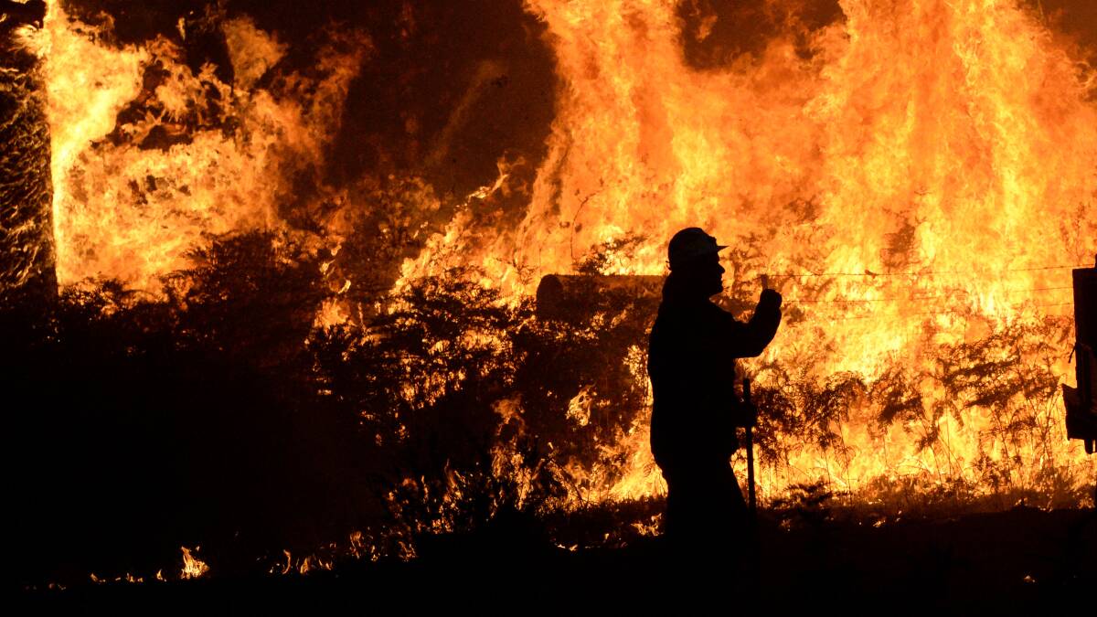 A firefighter backburns at a bushfire in Benloch in January. Picture: DARREN HOWE