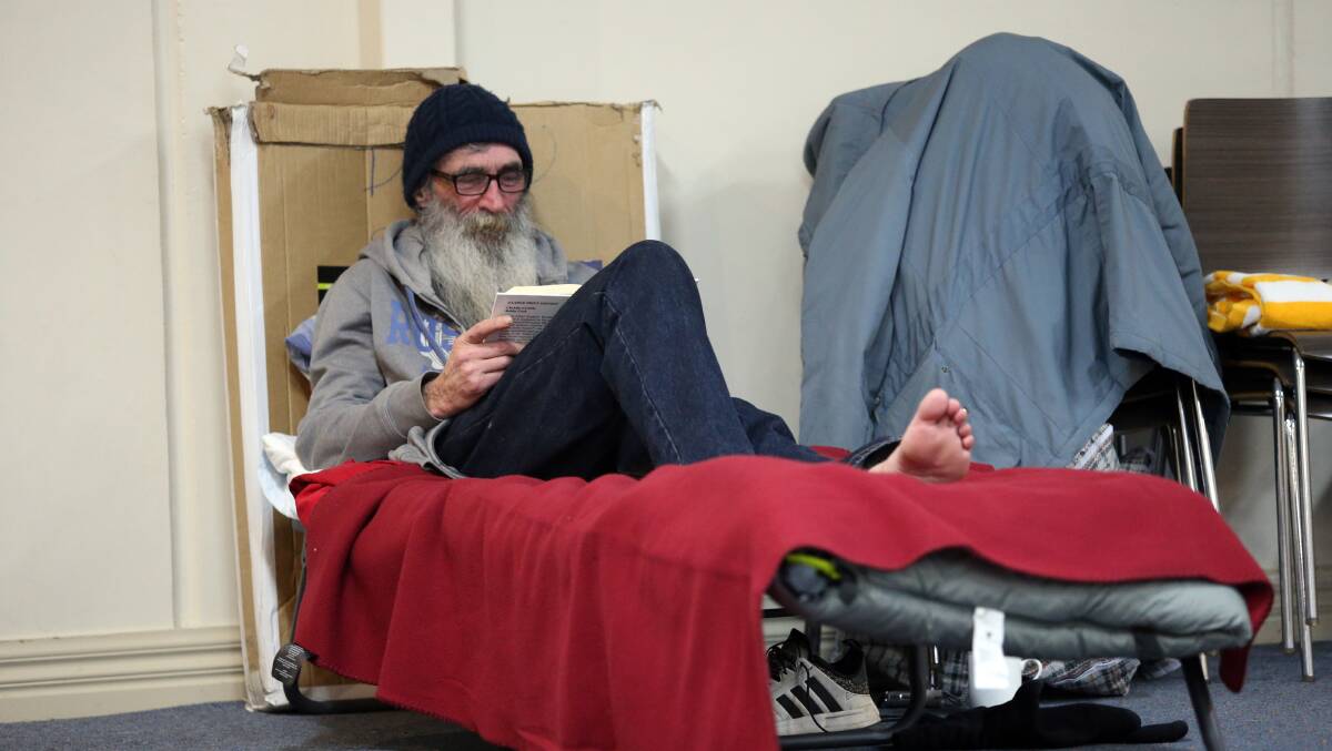 Don reads at the Bendigo Winter Night Shelter. Picture: GLENN DANIELS