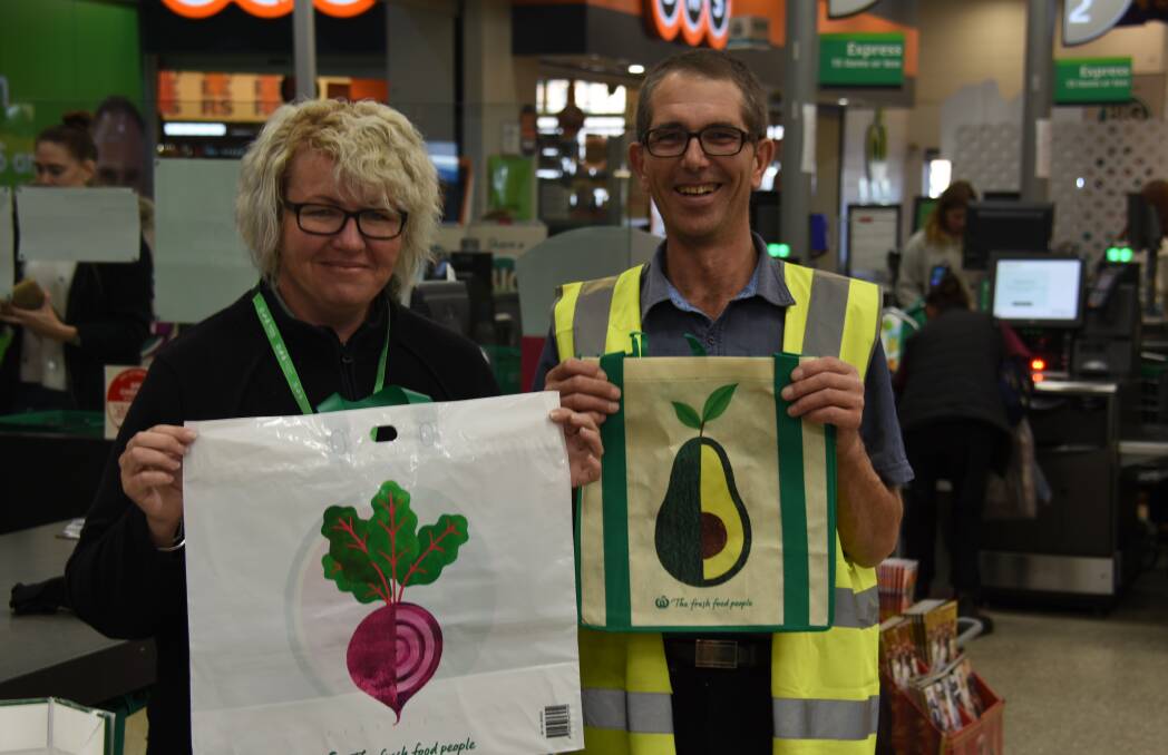 OUT WITH THE OLD: Woolworths Mudgee employee Tammy Windle and duty manager Brett McPherson are excited to launch a new range of reusable plastic bags on Wednesday, as well as encouraging the purchase of the already existing wholesale bags. Photo: Jake Humphreys