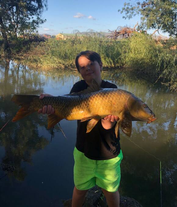CATCH OF THE DAY: William Stoffers hooked a huge carp on Thursday.